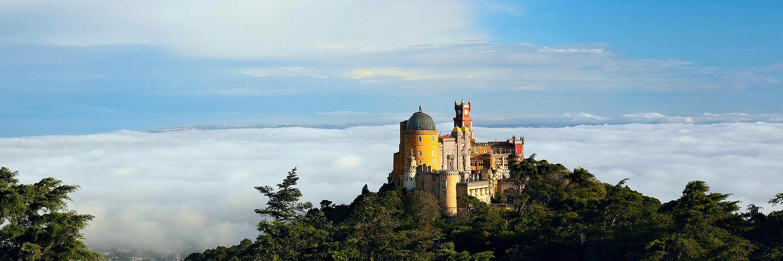 Birdview of Pena Palace emerging from the clouds
